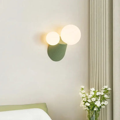 Modern sage green decorbites cactus resin glass wall lamp with two glowing spherical bulbs and textured base for bedroom