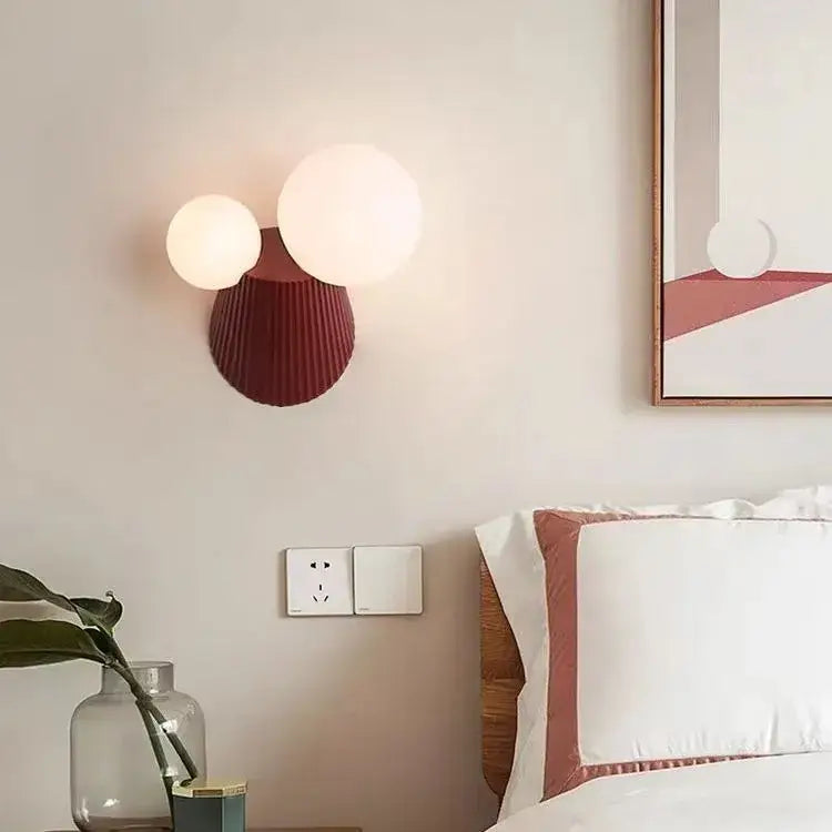 Modern wall lamp with two glowing white spherical bulbs on a deep red ribbed base for decorbites cactus resin glass