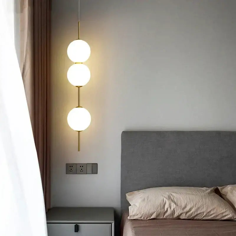 Modern sage green decorbites glass ball led pendant lamps with frosted glass spheres and gold-toned rods for living room decor