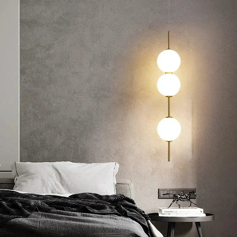 Modern three-bulb pendant lamps with frosted sage green glass balls and sleek brass finish for living room decorbites glass ball led