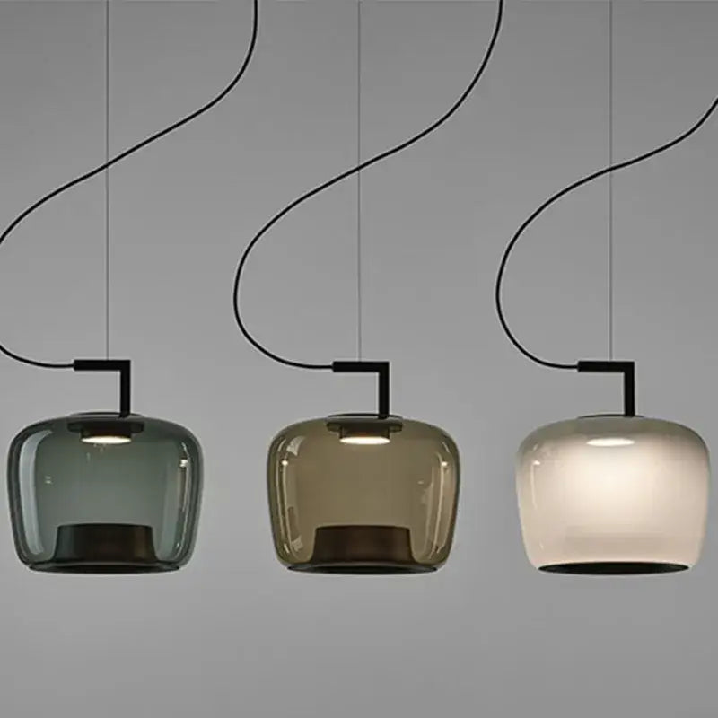 Modern sage green glass pendant lamp set of 3 with curved black cords and muted green amber frosted white shades for dining room