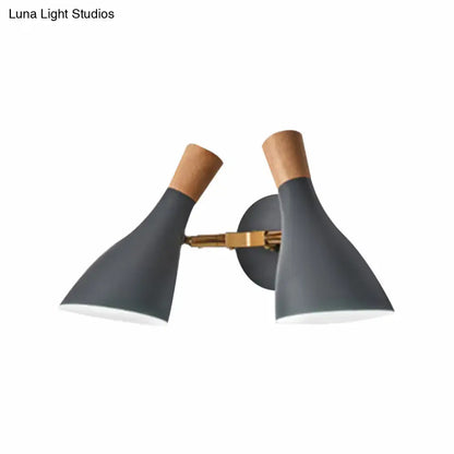Modern sage green and gray double shade wall sconce with matte gray conical shades natural wood accents and brass arm direct wired