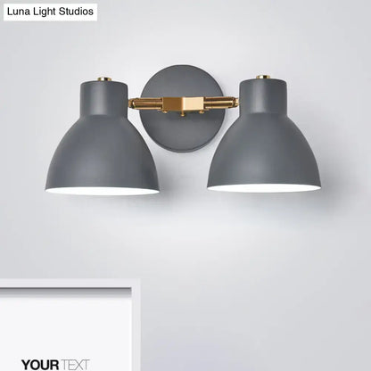 Modern sage green and gray double shade wall sconce with direct wired gray matte black shades and brass-finished arms