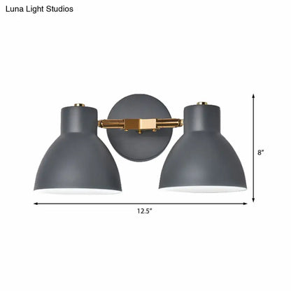 Modern gray and brass double shade wall sconce with two dome-shaped shades, 12 inches high for living room lighting