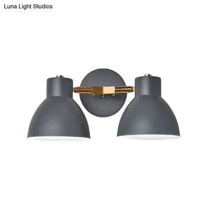 Modern sage green and gray double shade wall sconce with matte gray shades and brass accents measures inches high