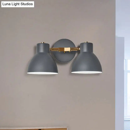 Modern sage green and gray double shade wall sconce with gray metal and brass accents, adjustable arms, 18 inches high