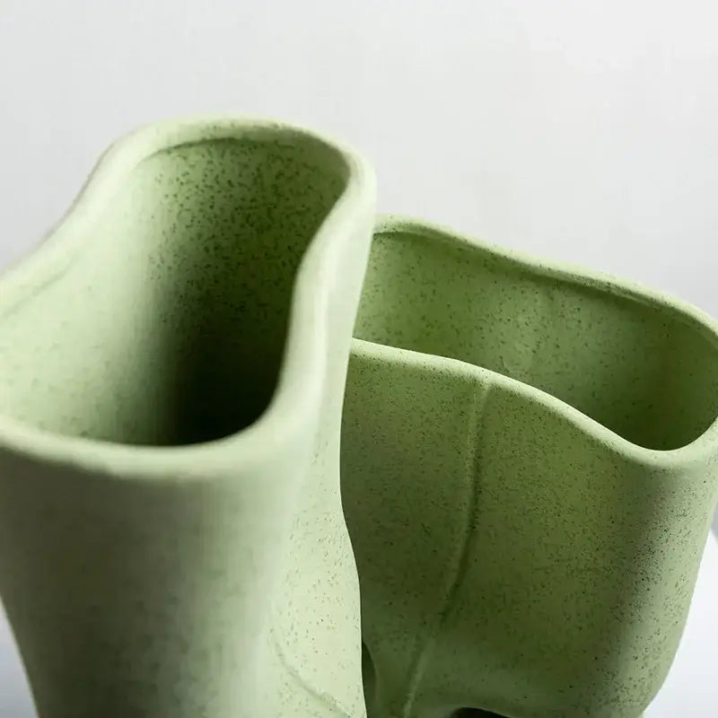 Modern sage green hollow ceramic vase set with light green speckled texture and organic asymmetrical shapes for living room decor