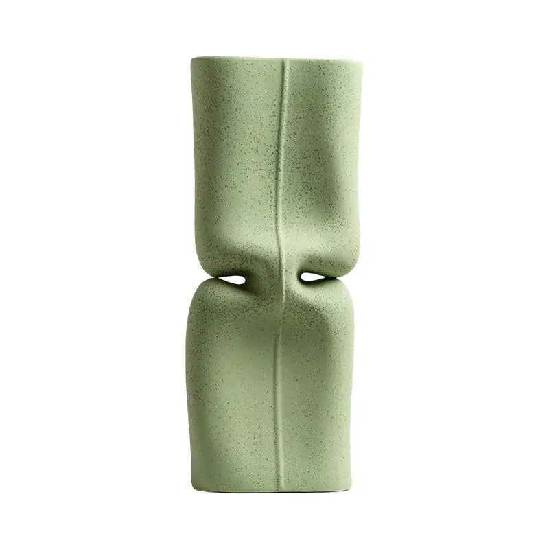Modern sage green hollow ceramic vase with a matte speckled finish and abstract symmetrical design for living room decor