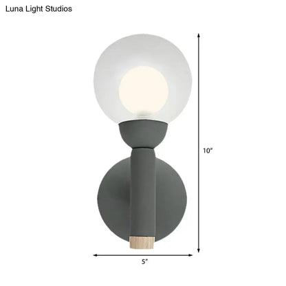 Modern sage green macaron style torch wall light with grey white frosted glass globe and wooden accent for bedroom sconce