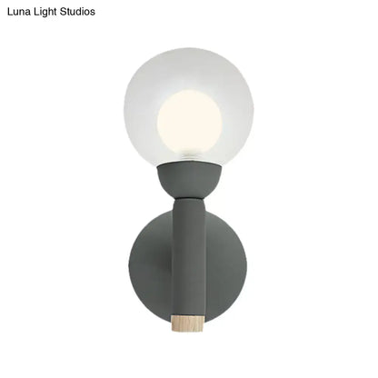 Modern sage green macaron style torch wall light with gray white frosted glass globe and wooden accent for bedroom sconce