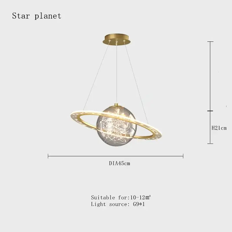 Gold-toned pendant lamp with clear glass sphere and glowing ring resembling a space star astronaut for boys bedroom