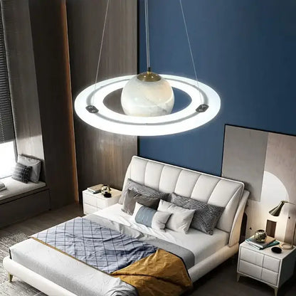 Modern pendant lamp with white marble sphere and glowing rings in boys bedroom star astronaut design