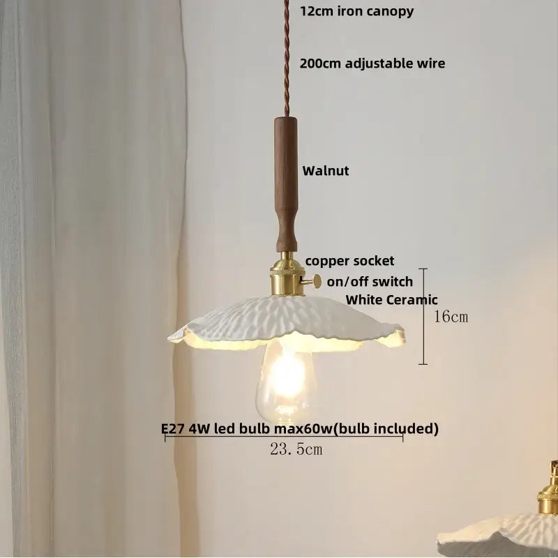 A delicate white ceramic led pendant light with scalloped floral design and warm glow for modern kitchen decorbites decor