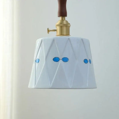 Modern scalloped floral ceramic led pendant light with white ceramic, blue oval sunglasses decals, and gold brass fixture