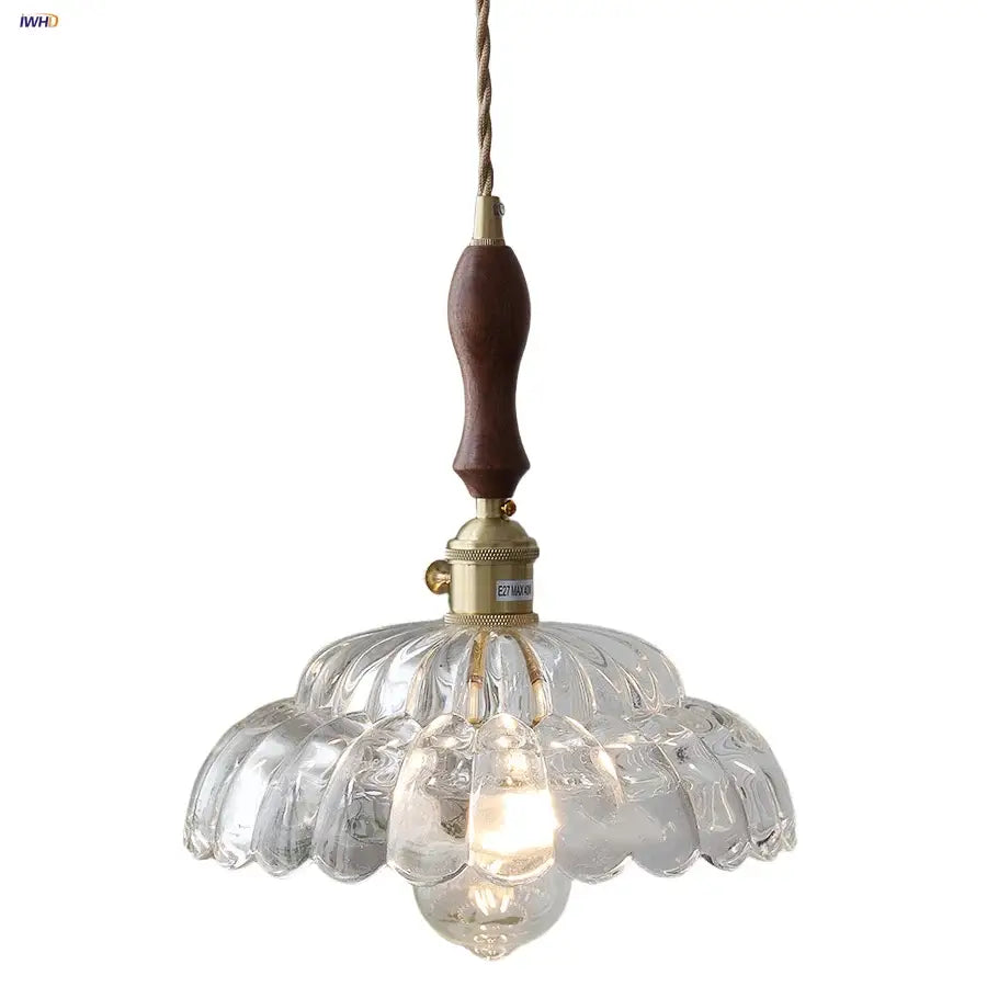 Modern scalloped glass flower led pendant light with clear glass, dark wood handle, and brass accents for dining room