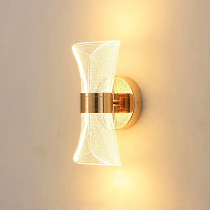 Modern sculptural decorbites gold nordic wall lights with gold tone and translucent textured acrylic shade shaped like a bow