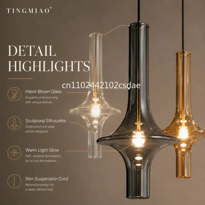Modern sculptural glass pendant light with black and amber hand-blown glass for elegant dining room lighting
