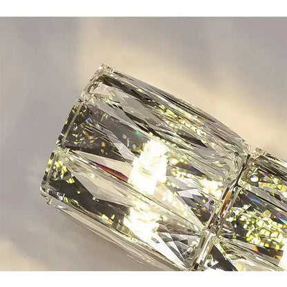 A modern crystal wall lamp with faceted transparent glass cubes in a sleek geometric pattern for living room decorbites crystal wall lamp
