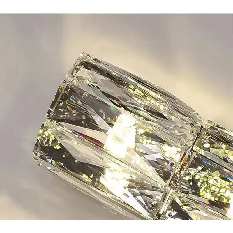 A modern crystal wall lamp with faceted transparent glass cubes in a sleek geometric pattern for living room decorbites crystal wall lamp