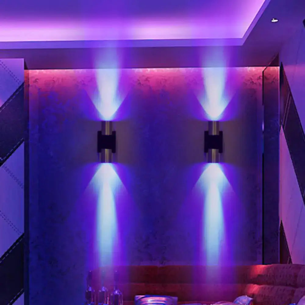 Modern silver aluminum wall light fixture with sleek cylindrical bodies emitting blue and purple accent lighting