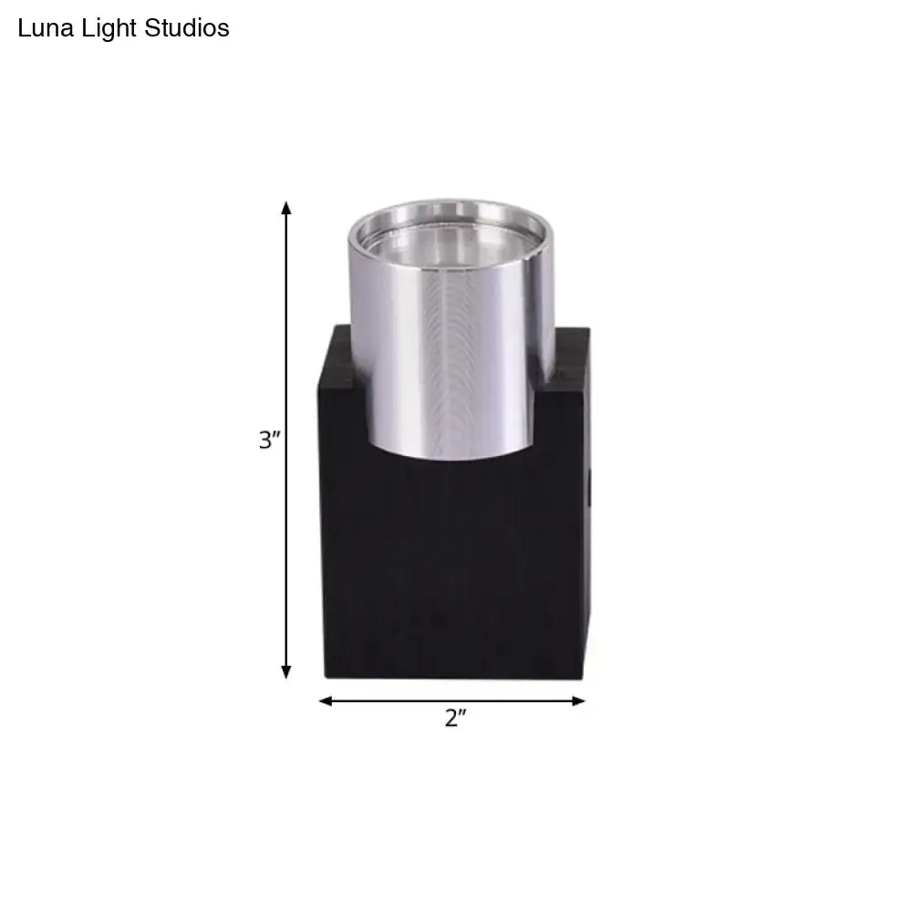Modern silver aluminum wall light fixture with brushed metal cylindrical holder on black base for bedroom accent lighting