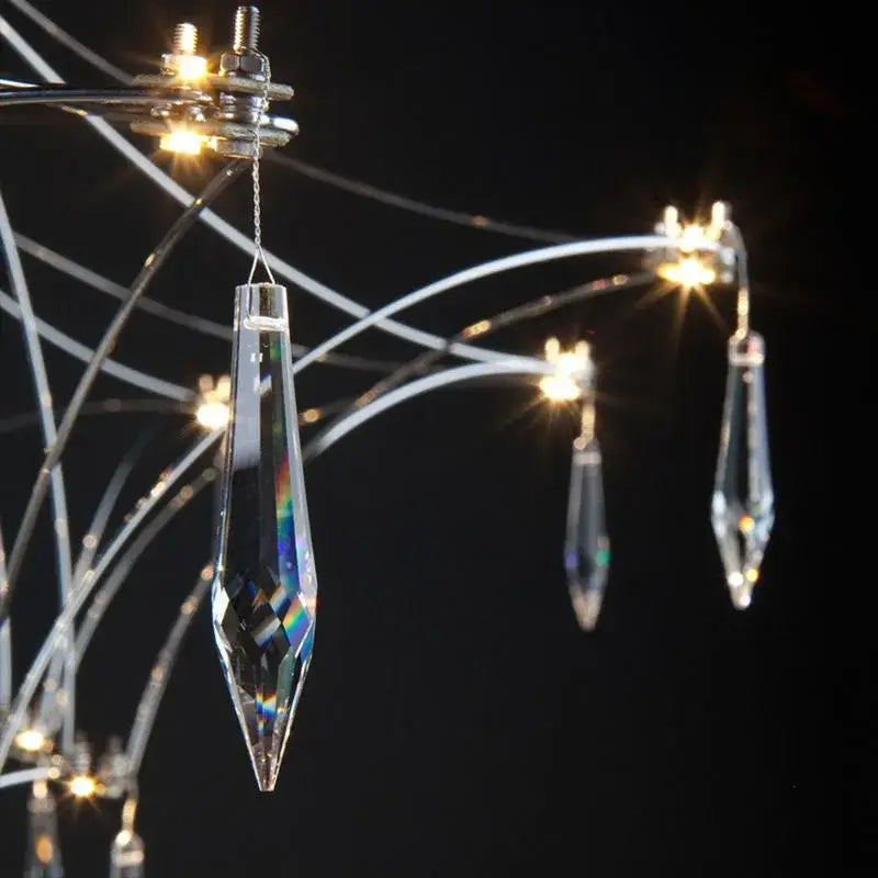 Clear faceted crystal pendant with pointed tip and reflective surfaces in modern silver and golden lustre crystal chandelier decorbites golden lustre