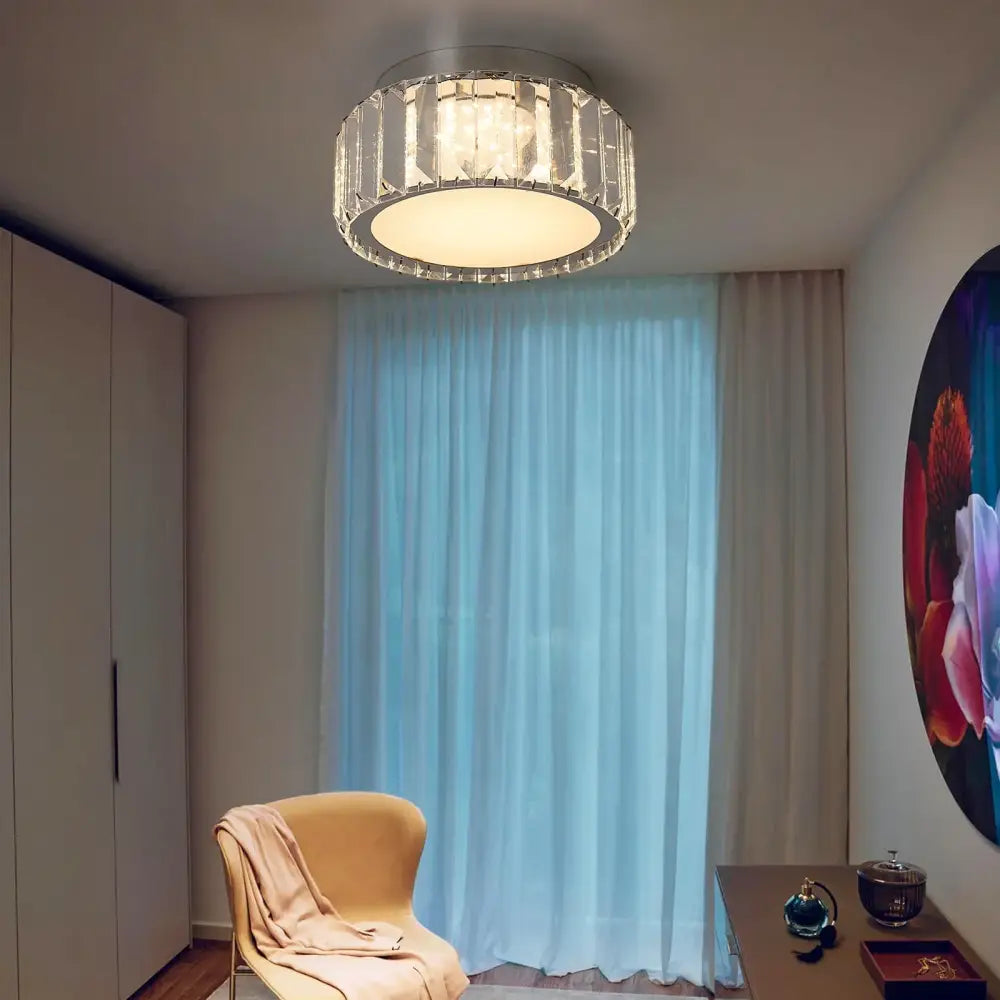 Modern silver ceiling lamp featuring big crystal led elements in a faceted crystal led circle for living room use