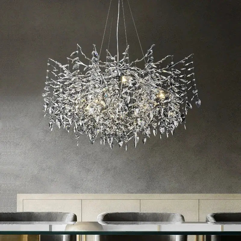 A modern silver and black decorbites crystal pendant chandelier with intricate leaf like branch design for dining room decor