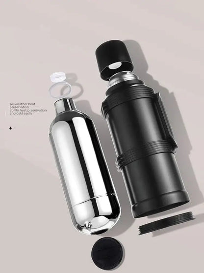 Modern silver and black insulated kettle with glass liner and folding handle featuring shiny chrome and matte black thermos bottles