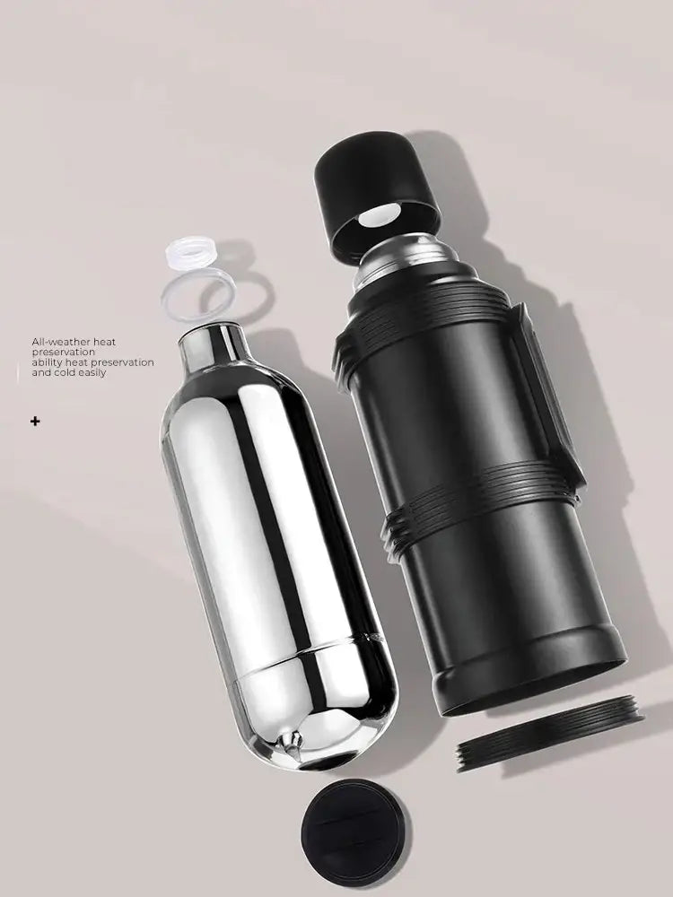 Modern silver and black insulated kettle with glass liner and folding handle featuring shiny chrome and matte black thermos bottles