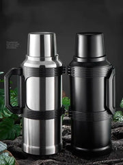 Modern silver and black insulated kettle with glass liner stainless steel thermos featuring textured grip and folding handle