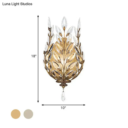Modern silver brass wall light with gold-toned laurel design and crystal drop for elegant bedroom decor