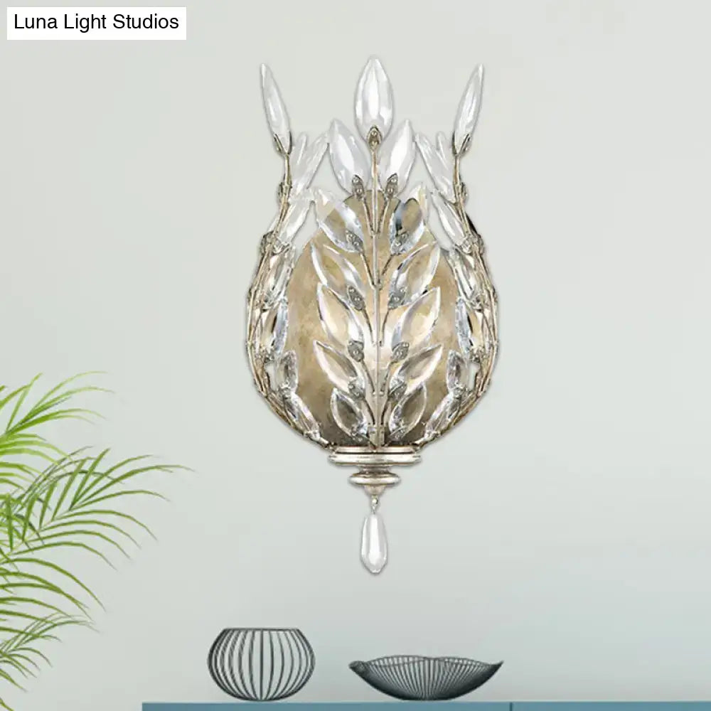Elegant silver brass wall light with leafy crystal drop design and clear glass accents for modern bedroom decor