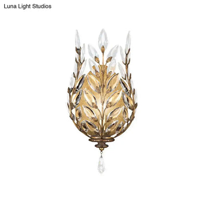 Gold-toned wall light with silver brass laurel design and crystal drop featuring intricate leaf and teardrop pendant details