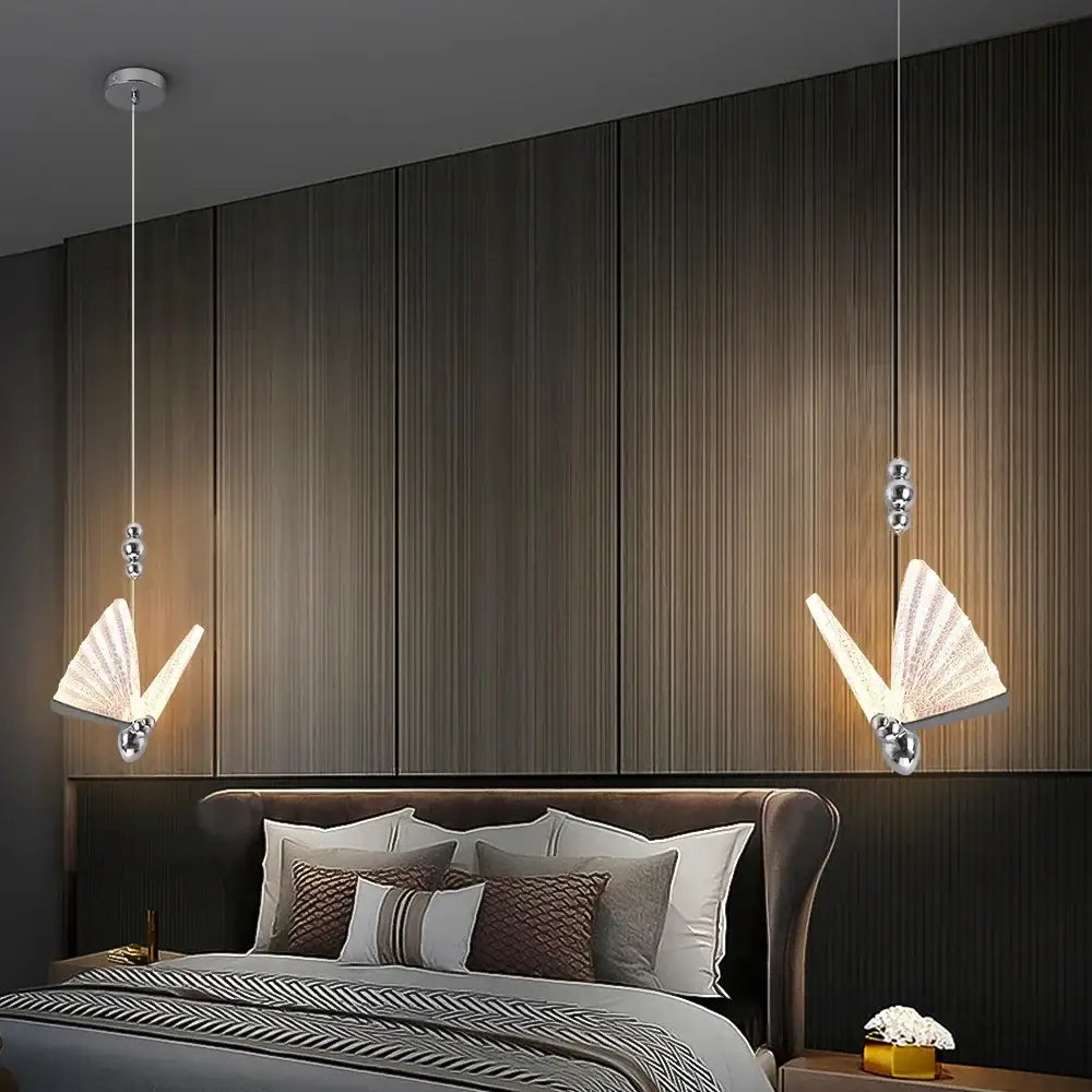 Modern silver butterfly led chandelier pendant light with fan-shaped diffusers and spherical accents above bed decorbites butterfly led
