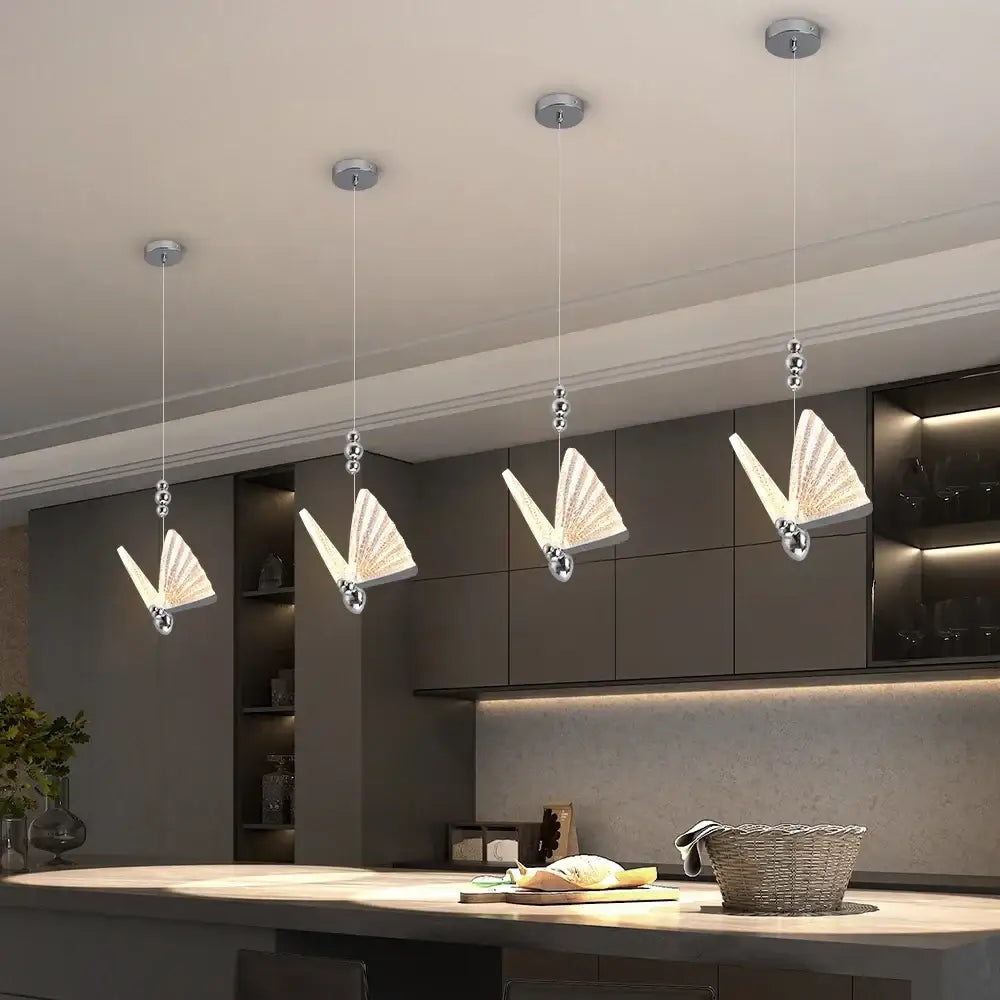 Modern silver butterfly led chandelier pendant light with sleek metal frames and translucent glass wings for dining room decorbites