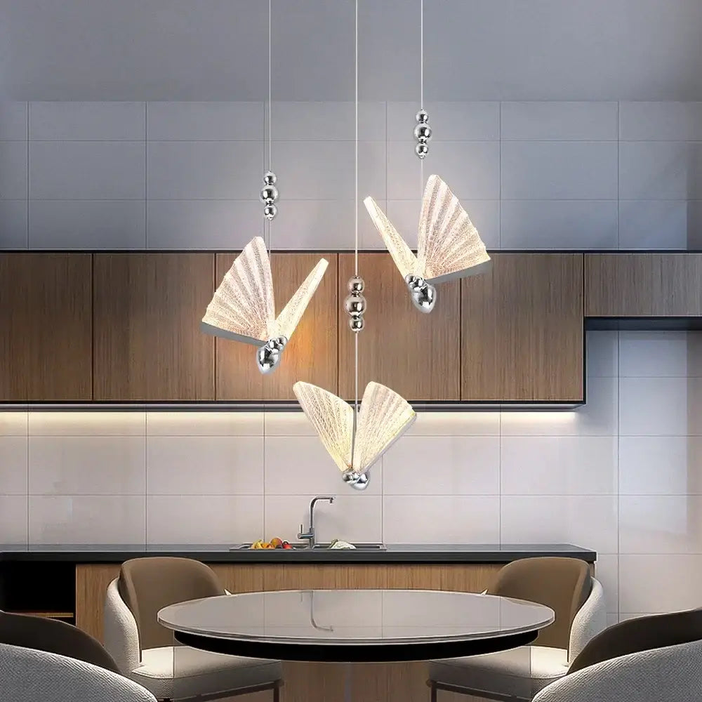 Three elegant translucent white butterfly led chandelier pendant lights with silver accents for modern dining room decorbites pendant light