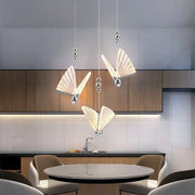 Three elegant translucent white butterfly led chandelier pendant lights with silver accents for modern dining room decorbites pendant light