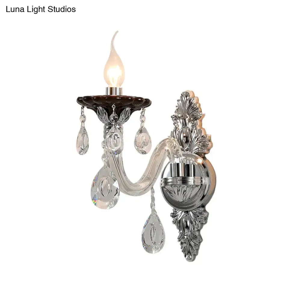 Elegant silver candle wall mounted sconce with chrome, crystal, and dark brown ceramic base featuring leaf motifs