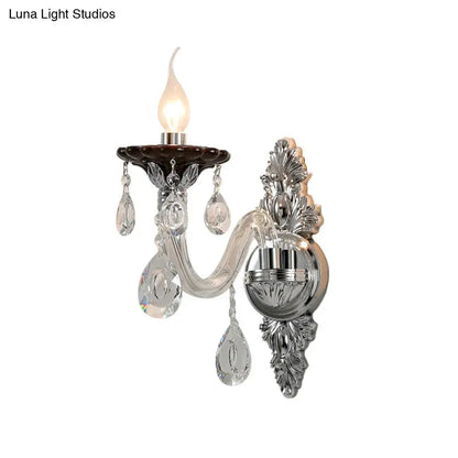 Elegant silver candle wall mounted sconce with chrome, crystal, and dark brown ceramic base featuring leaf motifs
