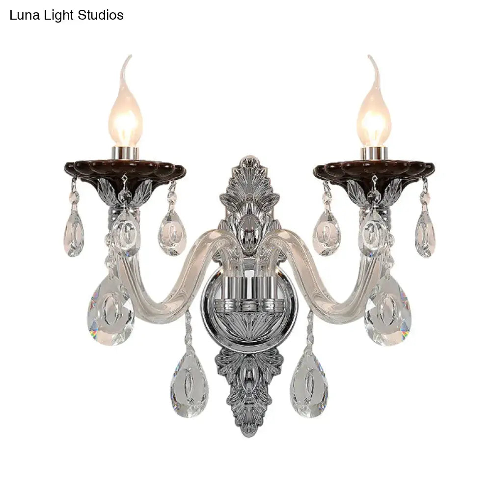 Elegant silver candle wall mounted sconce with chrome and crystal two-light design and dark brown ceramic holders