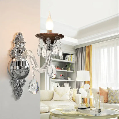 Modern silver candle wall mounted sconce with chrome finish dark brown ceramic base and dangling crystal droplets