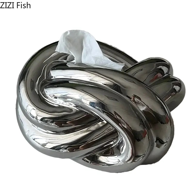 Modern silver ceramic knot tissue box with shiny chrome finish and twisted design for elegant living room decorbites ceramic knot decor