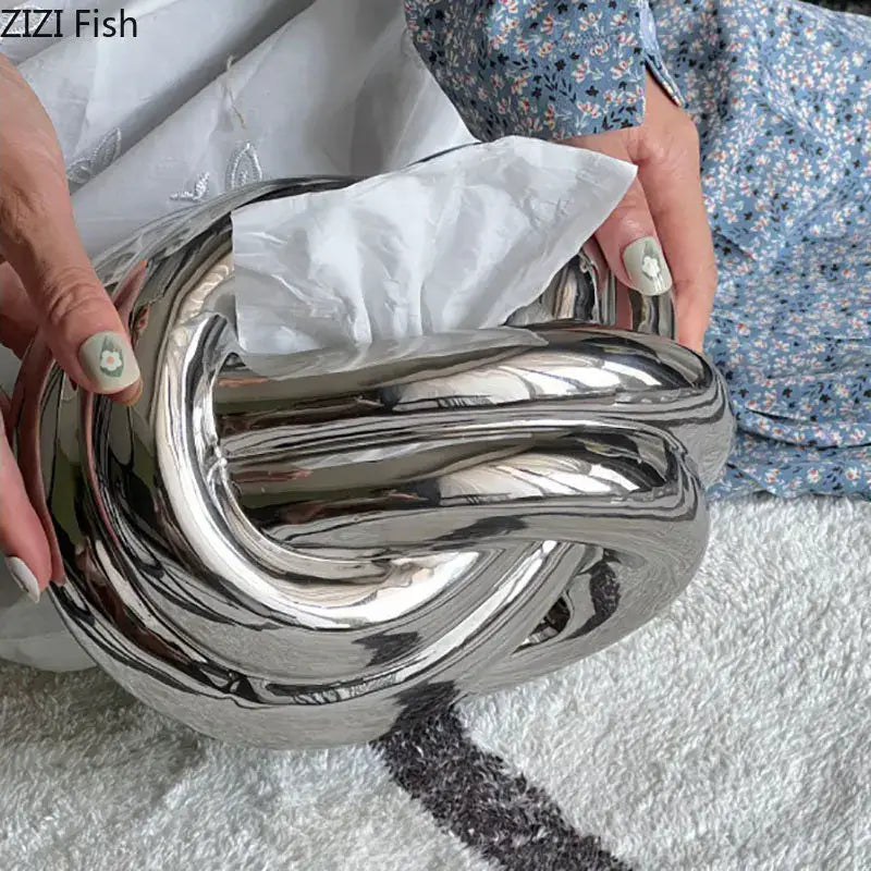 Modern silver ceramic knot tissue box with shiny metallic finish and twisted design for living room decorbites ceramic knot decor