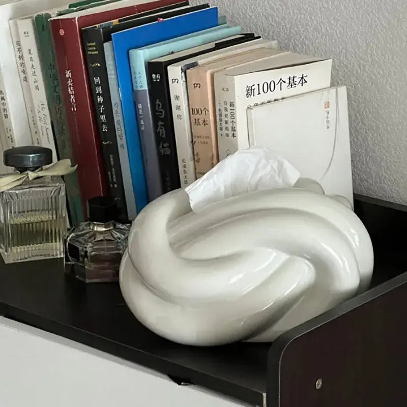 White ceramic knot tissue box with smooth glossy finish and elegant twisted design for modern living room decorbites ceramic knot