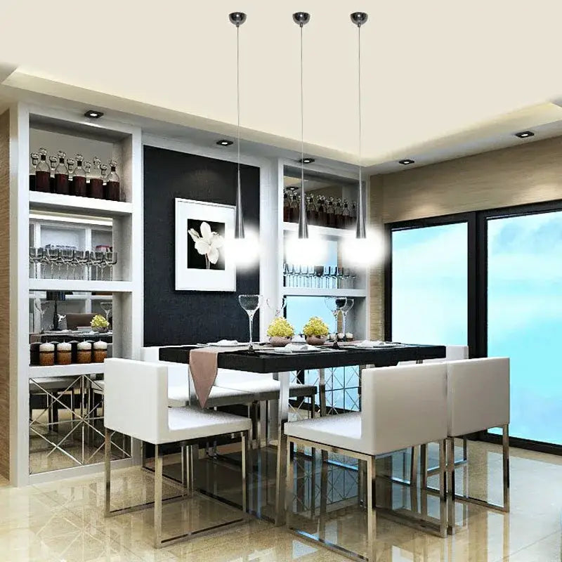 Modern silver conical pendant light 6 pack shown above a black dining table with chrome legs and minimalist white chairs decorbites pendant light
