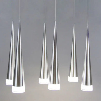 Six sleek silver decorbites conical pendant lights with frosted glass bases hanging in a modern dining room arrangement