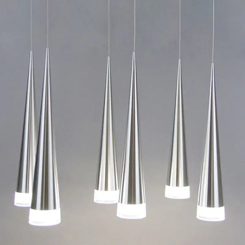 Six sleek silver decorbites conical pendant lights with frosted glass bases hanging in a modern dining room arrangement