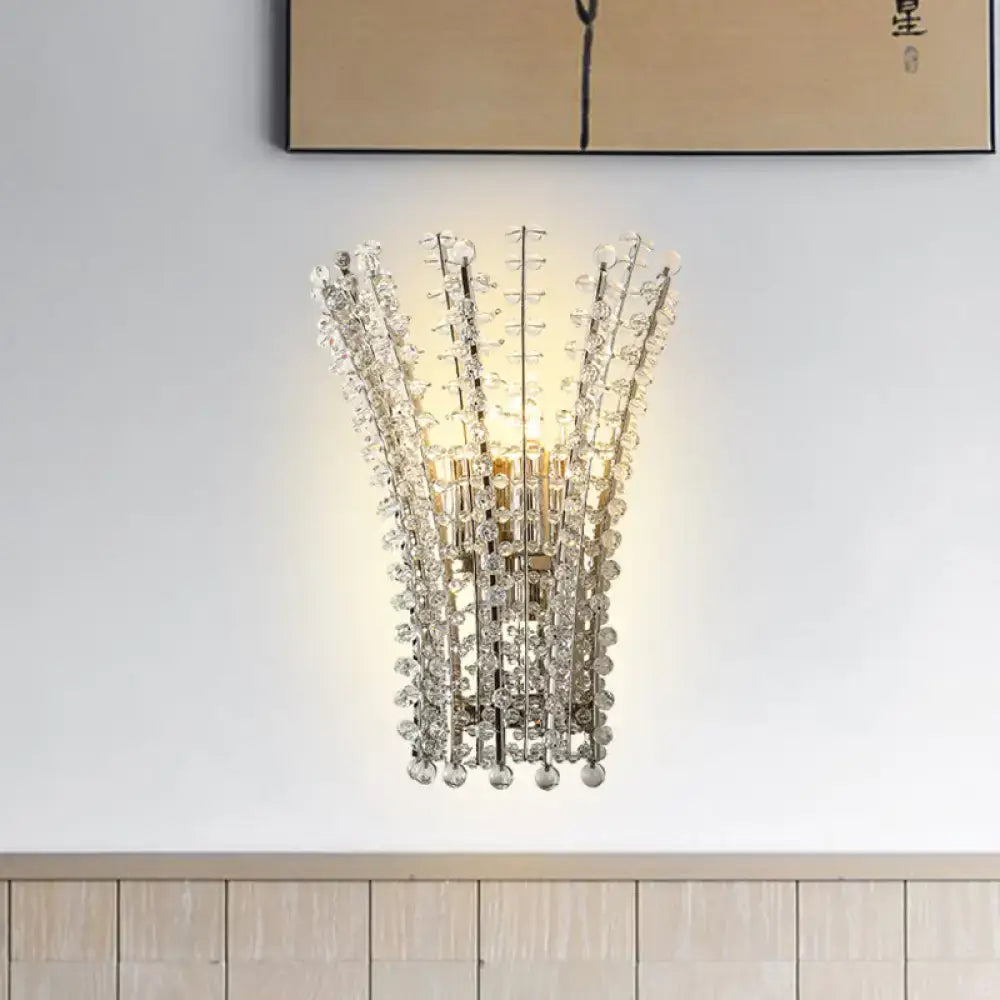 Modern silver crystal bead wall lamp featuring a polished gold-toned frame with cascading clear glass beads for bedroom use