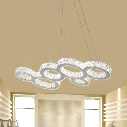 Modern crystal bubble led pendant with interconnected circular rings clear crystals and stainless steel frame over island